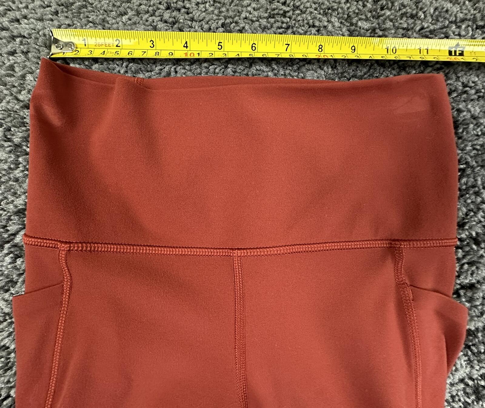 Athleta salutation Stash Pocket II Twist 7/8 Leggings Powervita Rust Red XS