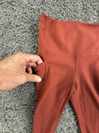 Athleta salutation Stash Pocket II Twist 7/8 Leggings Powervita Rust Red XS