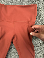 Athleta salutation Stash Pocket II Twist 7/8 Leggings Powervita Rust Red XS