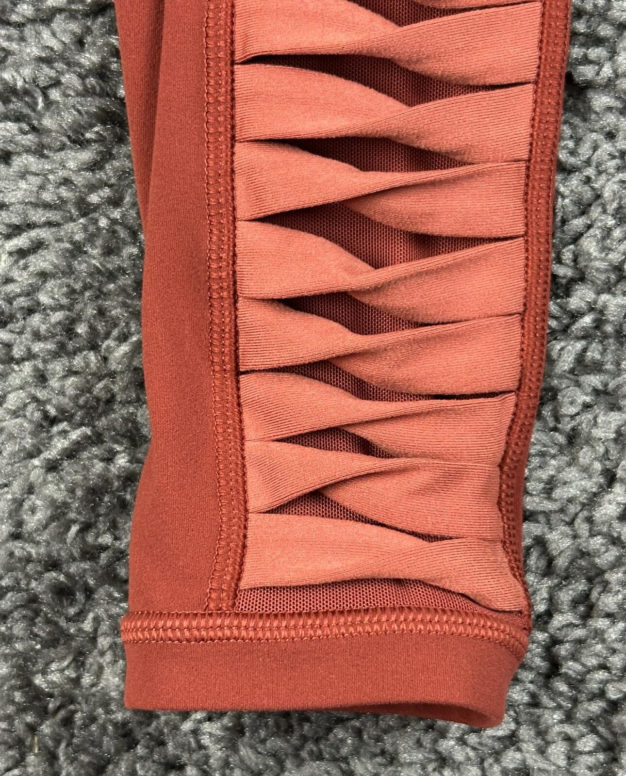 Athleta salutation Stash Pocket II Twist 7/8 Leggings Powervita Rust Red XS