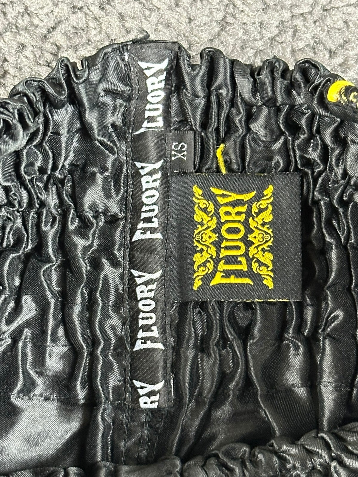 FLUORY Mens XS Black Muay Thai Shorts Gold Brocade Dragon Thai Script Boxing